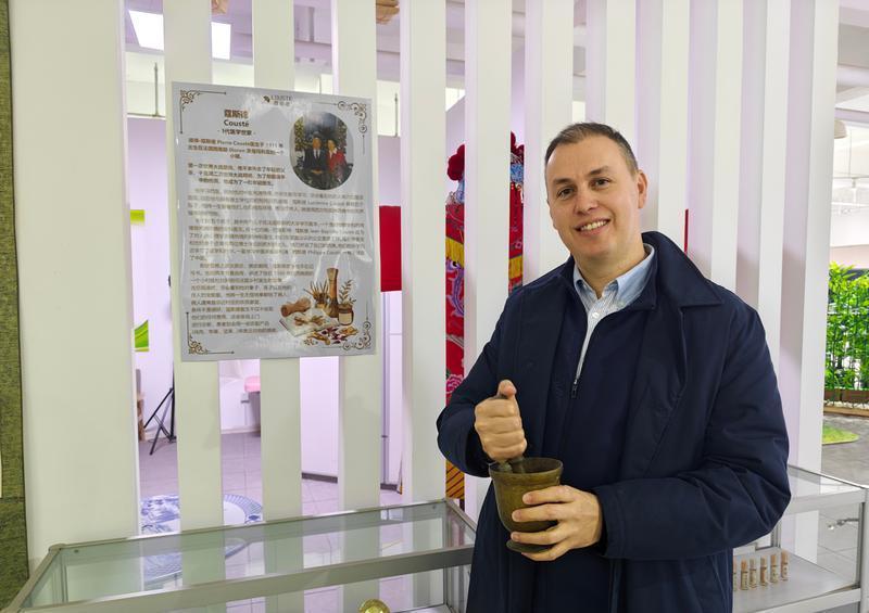 菲利普展示祖母曾经用过的中医器具——捣药罐。