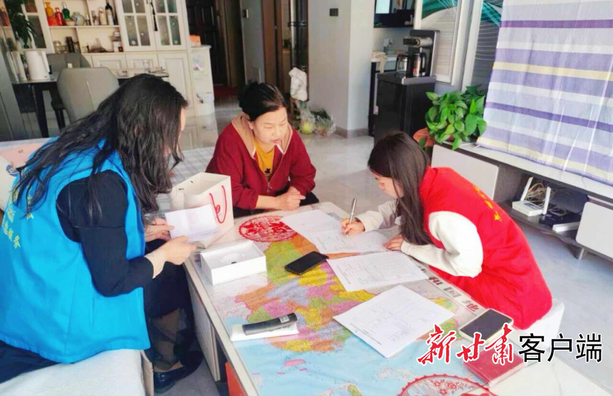 工作人员上门帮助老人填写补贴申请表(资料图)