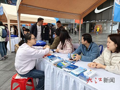 第十二届“12333统一咨询日”江西省主会场活动在南昌举行，图为外卖员在咨询社会保障事宜。