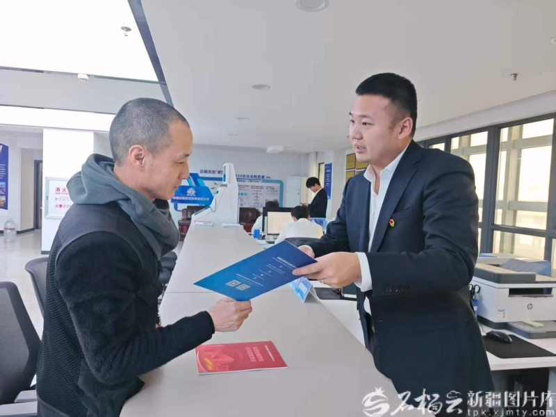 边疆宾馆市场采购贸易事业部负责人刘锡龙(右)给商户详细讲解“新贸通”综合服务平台备案流程。边疆宾馆供图