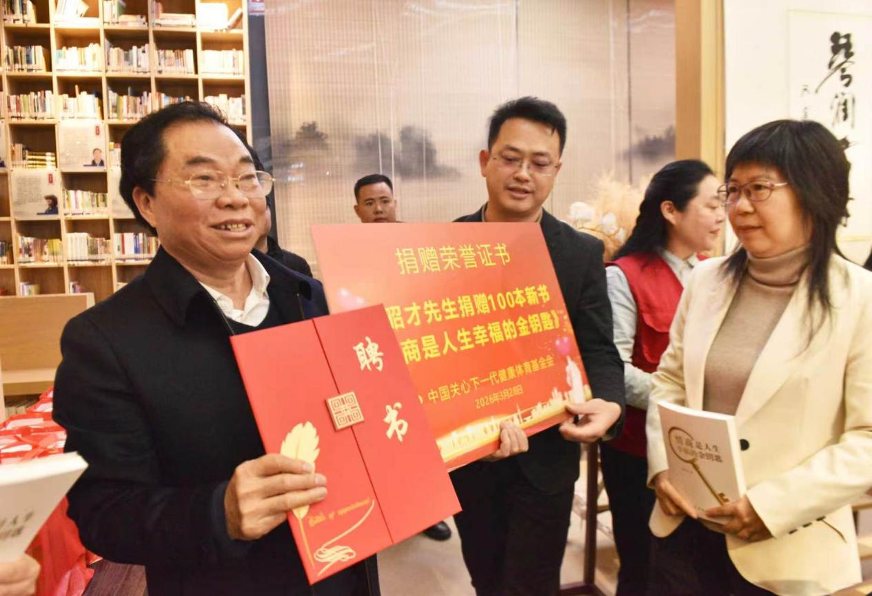 图为：爱心捐赠现场，中国关心下一代健康体育基金会文化体育发展基金执行主任曾芝冰与作者曾昭才先生合影留念。