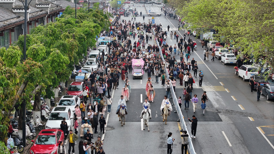 “古韵巡游”队伍沿着杨仙大道一路前行,吸引众多市民围观。