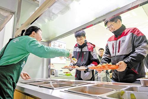 4月7日，快递小哥在“暖新食堂”取餐。本报记者 张 昊摄