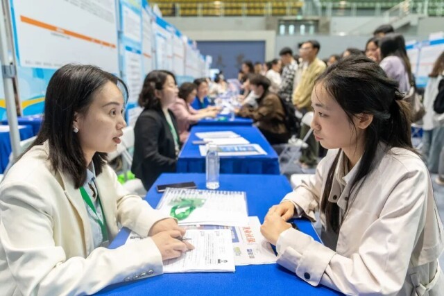 （4月18日，湖南大学体育馆，学生在了解岗位信息。湖南日报全媒体记者 傅聪 摄）