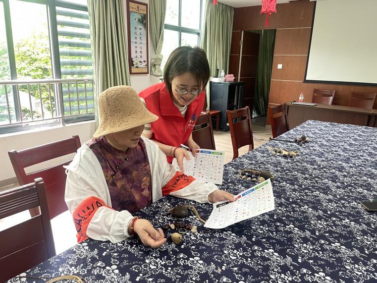 图为志愿者对居民进行垃圾分类知识宣讲