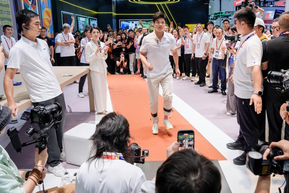 图为苏炳添在体博会现场测试跑道