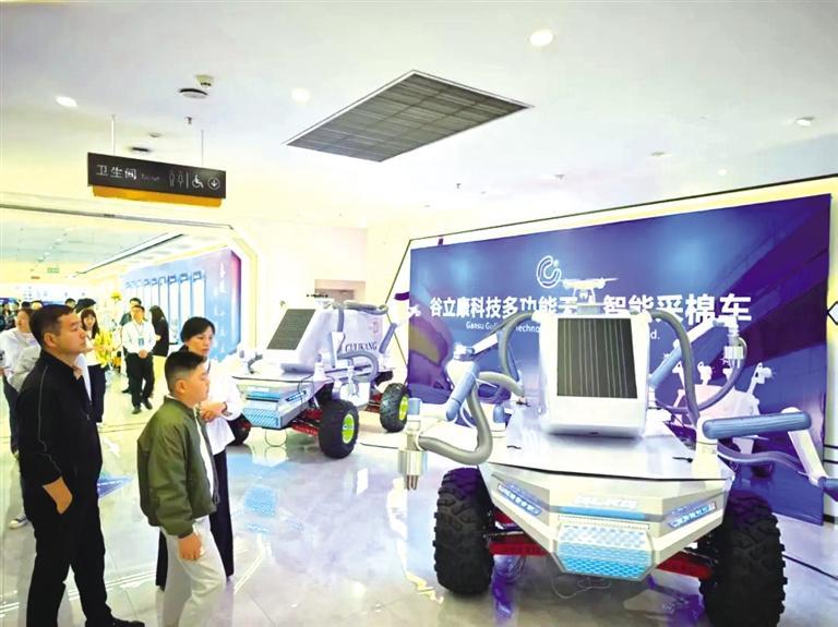 参观者在无人智能采棉车前驻足 何燕 摄