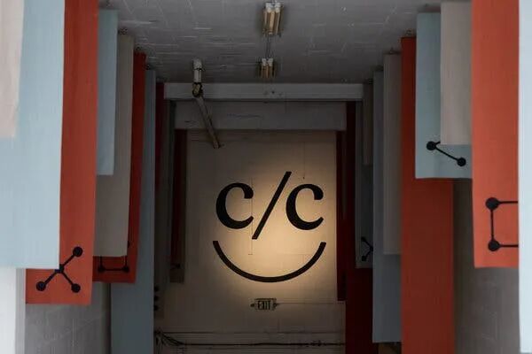 A Claude with Code logo on a wall.