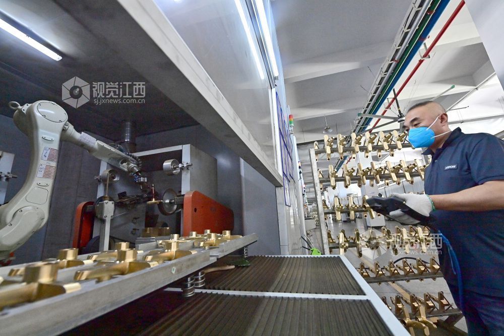 工人正在操作机器人自动化磨砂机 杨继红摄