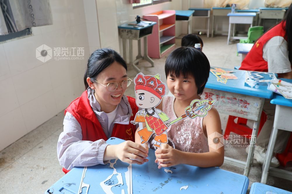 2026年7月28日,在江西省吉安市吉州区兴桥镇兴桥中心小学童心港湾,志愿者正在指导孩子们制作皮影人物。