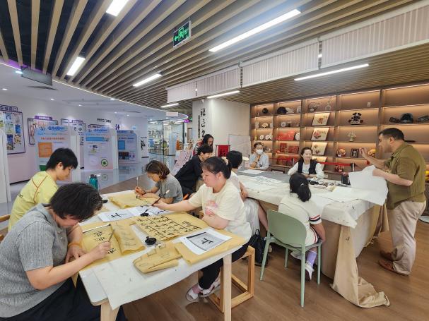 书画院的展架上,整齐陈列着一幅幅书法作品,既有落笔成型、工整圆润的完整“福”字,也有勤学苦练、初具雏形的基础笔画,新旧作品错落陈列、墨色层次分明。