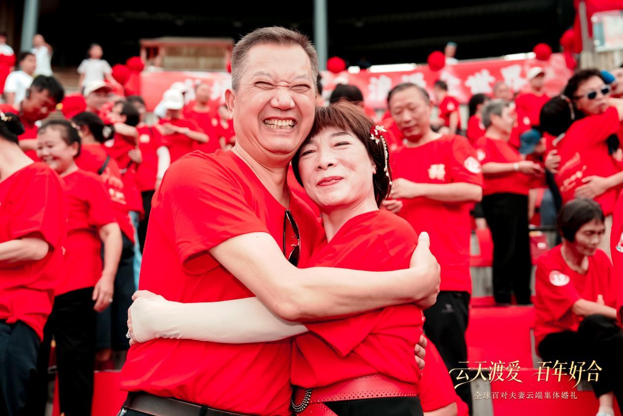 (集体婚礼现场,部分夫妻深情相拥)
