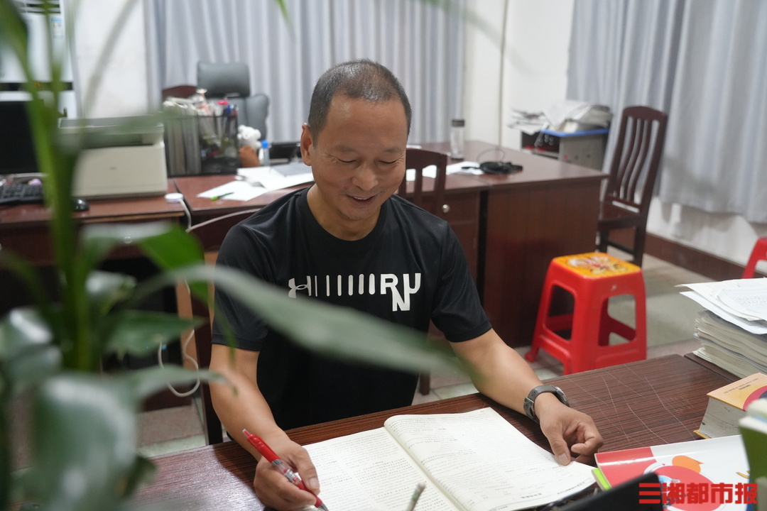 8月19日，李卯阶在岳云中学英语办公室备课。朱帅铭 摄