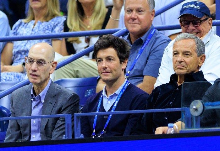 NBA Commissioner Adam Silver, Joshua Kushner, and Disney CEO Bob Iger sitting in the stands at the U.S. Open.