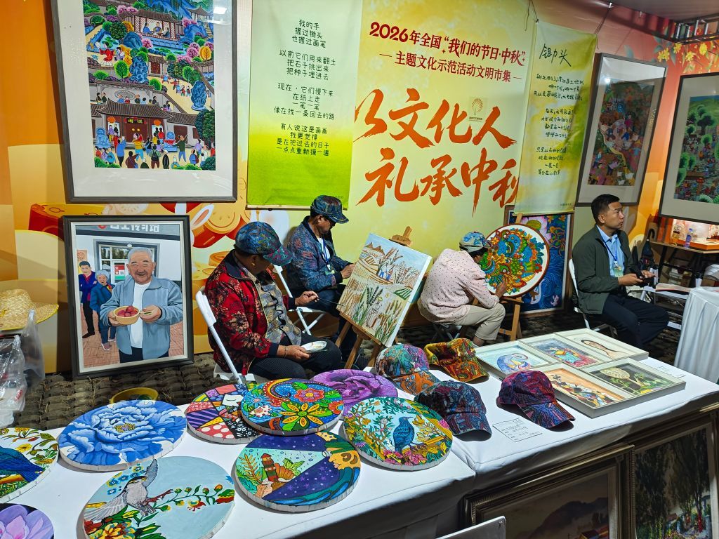 在诸城市超然台文明市集,蔡家沟村的农民画家在创作油画。新华社发