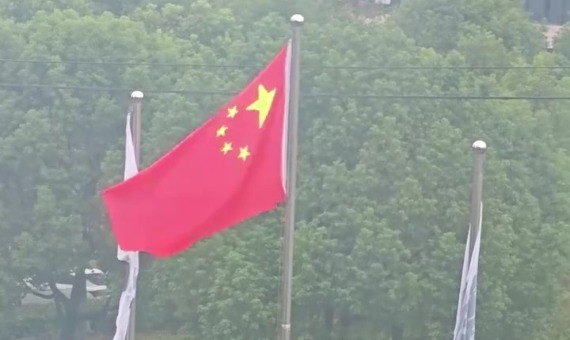 安徽一女子雨天唱《歌唱祖国》，湿润的五星红旗迎风飘扬