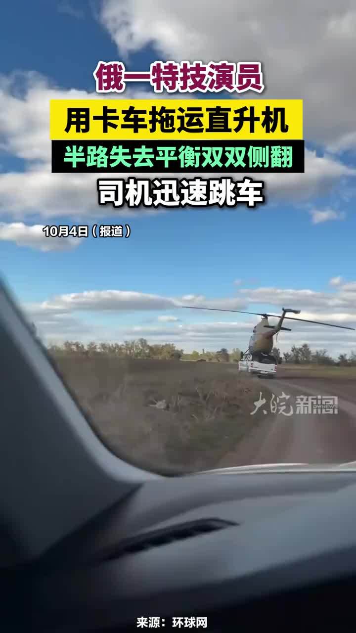 俄一特技演员用卡车拖运直升机，半路失去平衡双双侧翻，司机迅速跳车#俄特技演员用卡车运直升机侧翻
