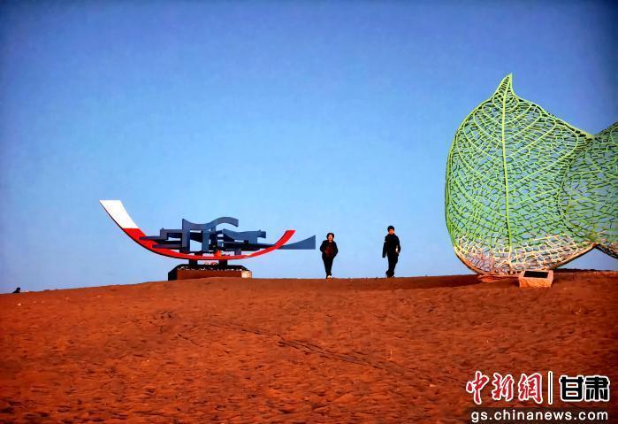 图为游客漫步在雕塑之间，感受大漠的艺术之美。富承璘　摄