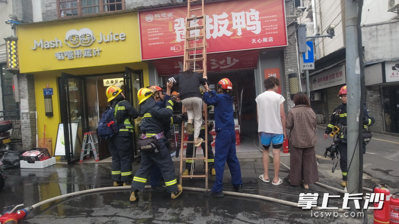 图为消防员在营救被困人员。长沙晚报通讯员 朱伟强 摄