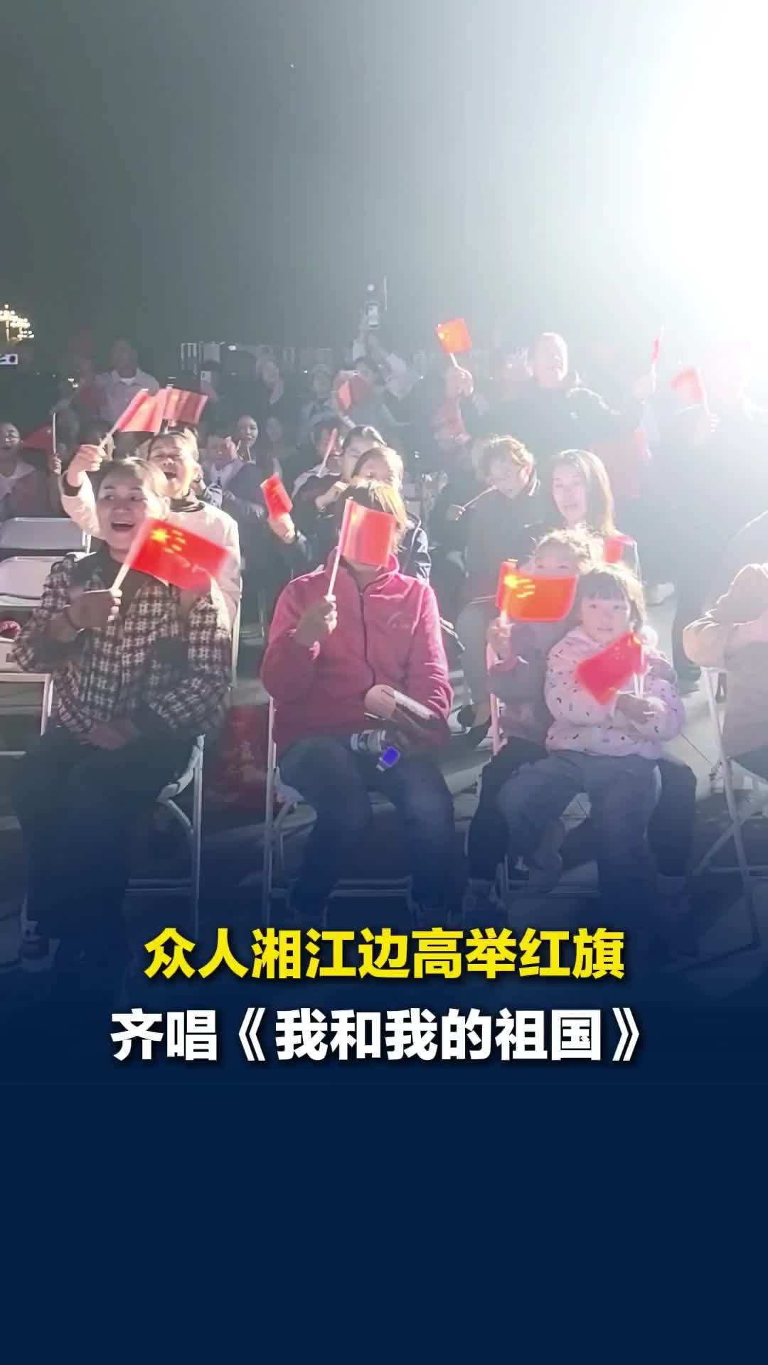 心里久久不能平静！湘江边众人高举红旗，齐声唱《我和我的祖国》，用歌声致敬先辈