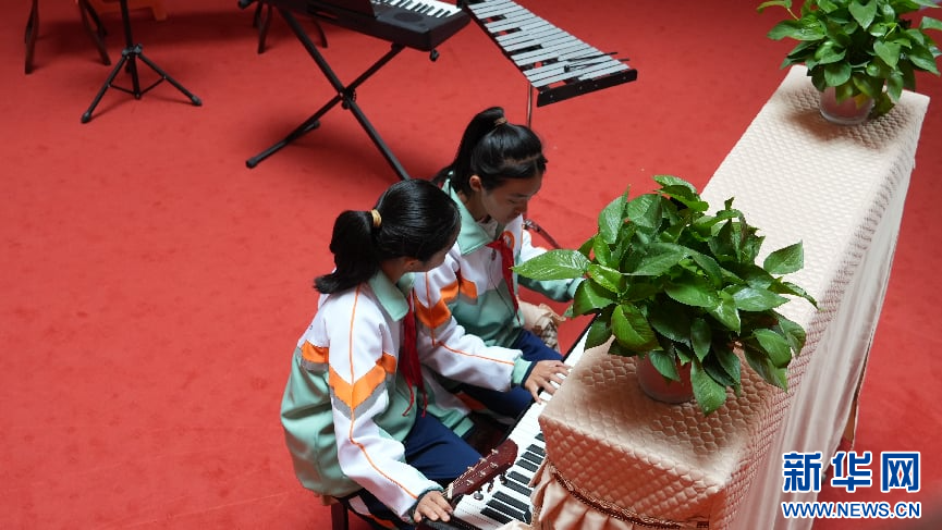 图为临夏七中的同学们在课后练习钢琴