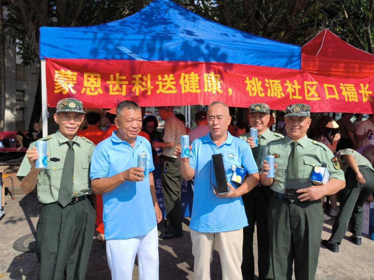 蒙恩齿科服务摊位前,长者们合影留念